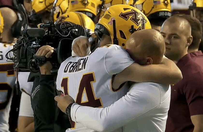 Casey O'Brien and Coach Fleck share a hug.